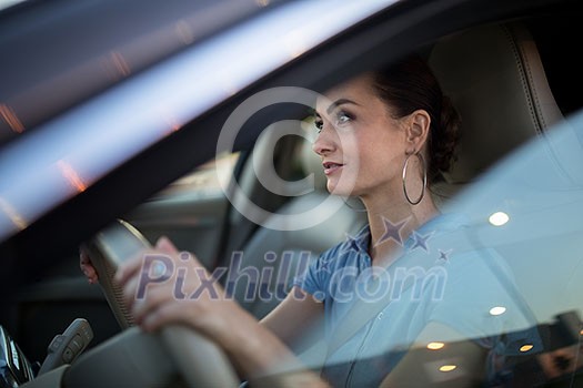 Pretty, young woman driving a car -Invitation to travel. Car rental or vacation. Pretty, young woman driving a car -Invitation to travel. Car rental or vacation.