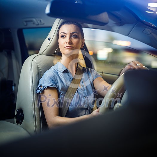 Pretty, young woman driving a car -Invitation to travel. Car rental, car ownership or vacation Pretty, young woman driving a car -Invitation to travel. Car rental, car ownership or vacation