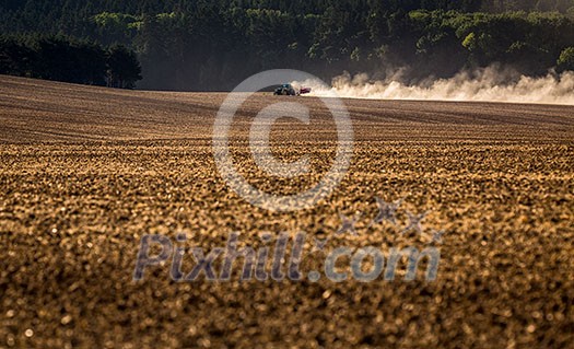 Tractor plowing a dry farm field Tractor plowing a dry farm field