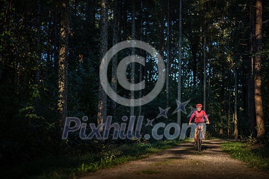 Pretty, young woman biking on a mountain bike enjoying healthy active lifestyle outdoors in summer (shallow DOF) Pretty, young woman biking on a mountain bike enjoying healthy active lifestyle outdoors in summer (shallow DOF)