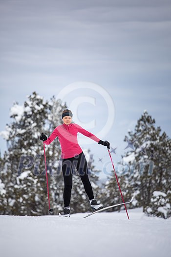 Cross-country skiing: young woman cross-country skiing on a winter day Cross-country skiing: young woman cross-country skiing on a winter day