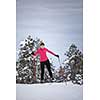 Cross-country skiing: young woman cross-country skiing on a winter day