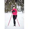 Cross-country skiing: young woman cross-country skiing on a winter day