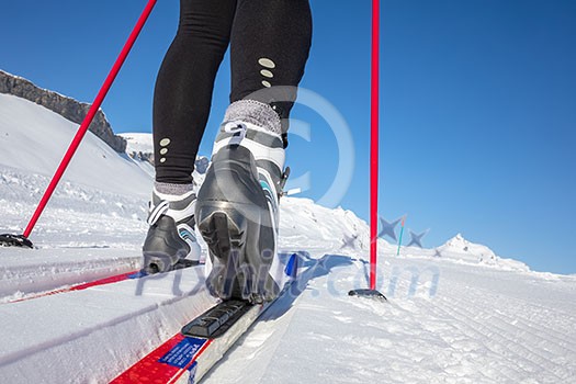 Cross-country skiing: young woman cross-country skiing on a winter day (motion blurred image) Cross-country skiing: young woman cross-country skiing on a winter day (motion blurred image)