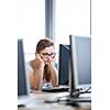 Pretty, female student looking at a desktop computer screen, learning unpleasant news about her exam results. University/office/school concept