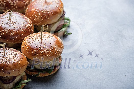 Homemade juicy burgers with beef, cheese and caramelized onions. Street food, fast food. Copyspace Homemade juicy burgers with beef, cheese and caramelized onions. Street food, fast food. Copyspace