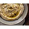 Delicious hummus with pine nuts and olive oil. Top view. Close-up.