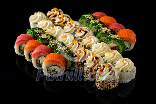 Fresh Sushi rolls set served on black background. Japanese seafood sushi. Fresh Sushi rolls set served on black background. Japanese seafood sushi.