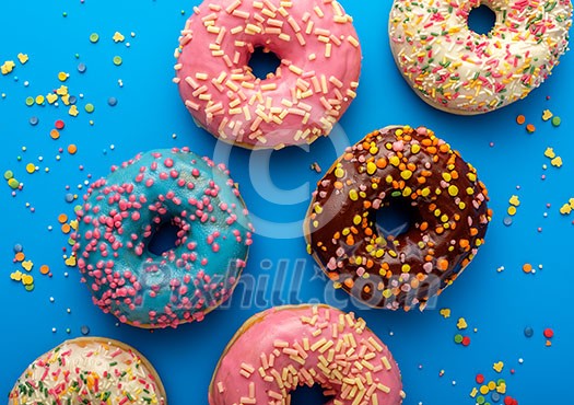 Variety of colorful tasty glazed donuts on a colored background. Variety of colorful tasty glazed donuts on a colored background.