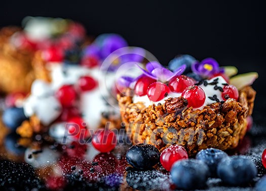 Dessert with sunflower seeds, yogurt and fresh berries on black Dessert with sunflower seeds, yogurt and fresh berries on black