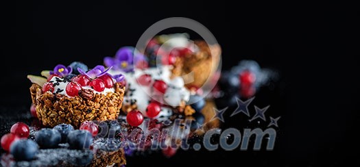 Dessert with sunflower seeds, yogurt and fresh berries on black Dessert with sunflower seeds, yogurt and fresh berries on black