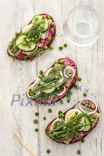 Sandwich with herring, horseradish and fresh herbs. Top view. Sandwich with herring, horseradish and fresh herbs. Top view.
