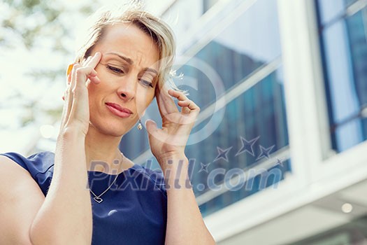 Businesswoman standing in street and trying to concentrate Businesswoman standing in street and trying to concentrate