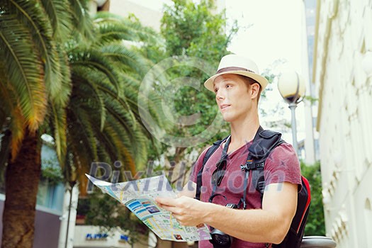 Happy young man with a map Happy young man with a map
