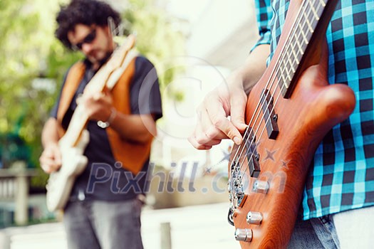 A street musician playing his guitar A street musician playing his guitar