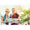 Happy young couple as tourists with a map
