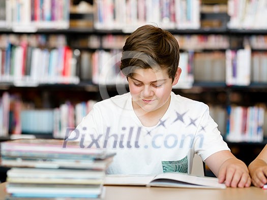 Boy in library with books Boy in library with books
