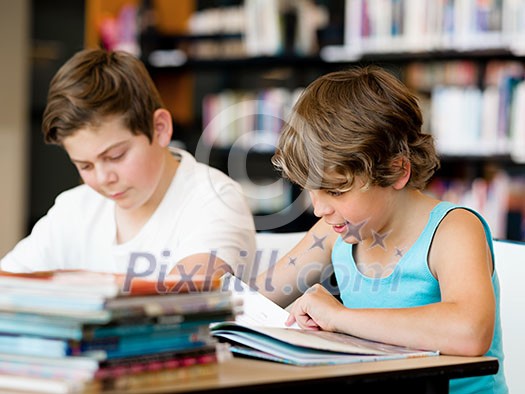 Two boys in library with books Two boys in library with books