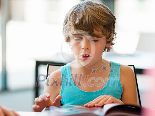 Boy in library with books Boy in library with books