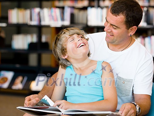 Father with son in library with books Father with son in library with books