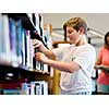Boy in library choosing books