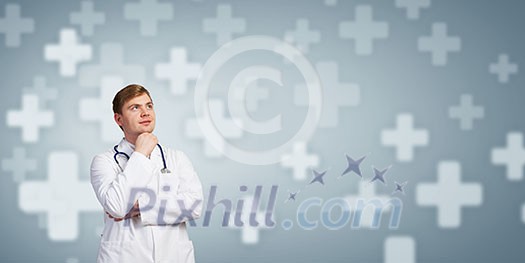 Young man doctor seriously thinking something over Young man doctor seriously thinking something over