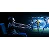 Man sitting on sofa and playing soccer game with joystick. Mixed media