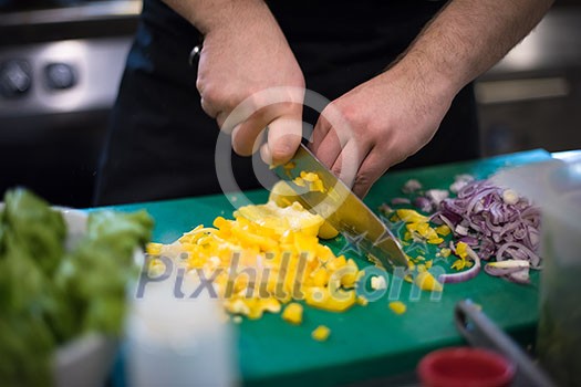 Chef hands cutting fresh and delicious vegetables for cooking or salad Chef hands cutting fresh and delicious vegetables for cooking or salad