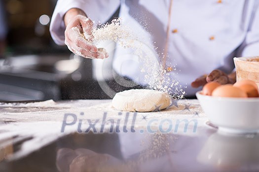 chef hands preparing dough for pizza on table sprinkled with flour closeup chef hands preparing dough for pizza on table sprinkled with flour closeup