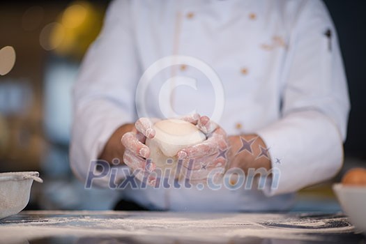 chef hands preparing dough for pizza on table sprinkled with flour closeup chef hands preparing dough for pizza on table sprinkled with flour closeup