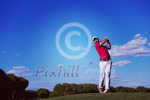 golf player hitting shot with driver on course at beautiful sunny day golf player hitting shot with driver on course at beautiful sunny day