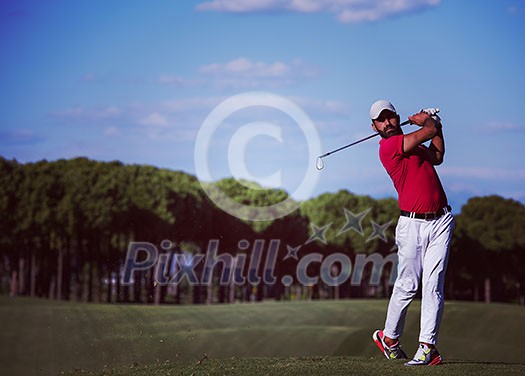 golf player hitting shot with driver on course at beautiful sunny day golf player hitting shot with driver on course at beautiful sunny day