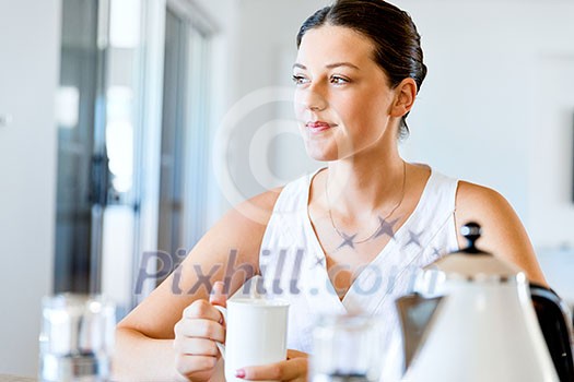 Attractive young woman with cup of tea or coffee at home Attractive young woman with cup of tea or coffee at home