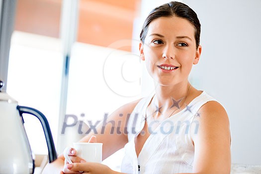 Attractive young woman with cup of tea or coffee at home Attractive young woman with cup of tea or coffee at home