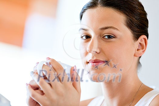 Attractive young woman with cup of tea or coffee at home Attractive young woman with cup of tea or coffee at home