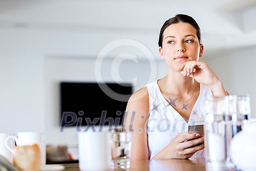 Portrait of young attractive woman holding mobile phone Portrait of young attractive woman holding mobile phone