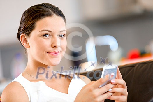 Portrait of young attractive woman holding mobile phone Portrait of young attractive woman holding mobile phone