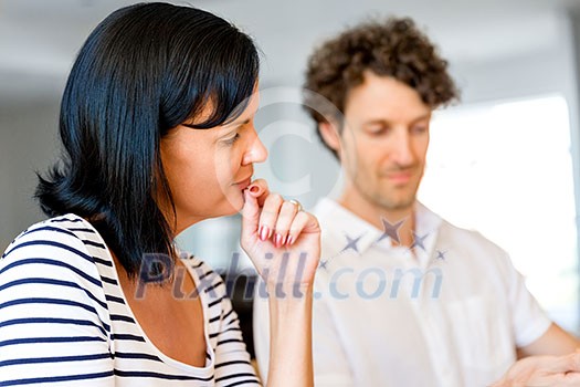 Happy modern couple surfing the net and working on laptop at home Happy modern couple surfing the net and working on laptop at home
