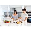 Couple cooking together in the modern kitchen at home