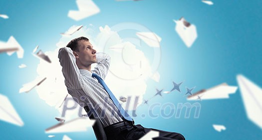 Relaxed businessman at the office sitting with his hands behind his head Relaxed businessman at the office sitting with his hands behind his head