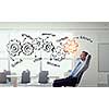Relaxed businessman at the office sitting back with his hands behind his head