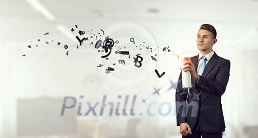 Businessman spraying his business symbols from aerosol can Businessman spraying his business symbols from aerosol can