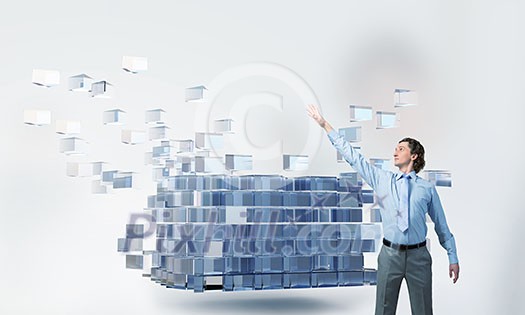 Businessman reaching hand to touch 3D rendering cube figure Businessman reaching hand to touch 3D rendering cube figure