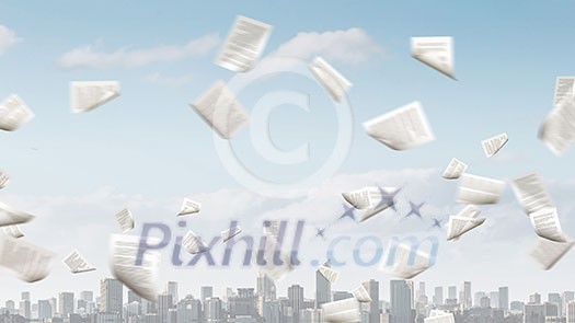 Modern business cityscape and papers flying in air Modern business cityscape and papers flying in air