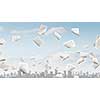 Modern business cityscape and papers flying in air