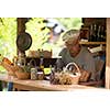 senior man gardener herbalist picking gathering fresh herbs for alternative medicine tea and poutting on balance