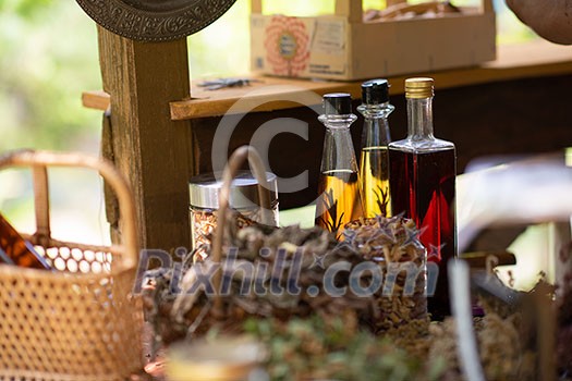 tincture or potion bottle in hand of herbalist bunch of dry healthy herbs in background alternative medicine tincture or potion bottle in hand of herbalist bunch of dry healthy herbs in background alternative medicine