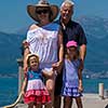 portrait of  happy grandparents with cute little granddaughters standing by the sea during Summer vacation  Healthy family holiday concept