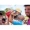 cute little girl having fun with her young father while eating ice cream by the sea during summer vacation holidays, celebration, children and people concept