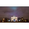 Paris, France - August 04, 2006: Beautiful view of the Arc de Triomphe du Carrousel in the evening against the backdrop of street lamps.